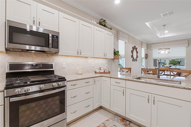 kitchen featuring ornamental molding, stainless steel appliances, sink, and white cabinets