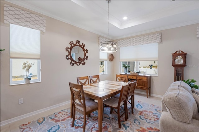 dining space featuring crown molding, light tile patterned flooring, and a raised ceiling