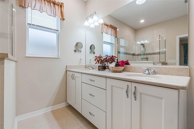 bathroom with vanity, plenty of natural light, tile patterned floors, and tiled shower