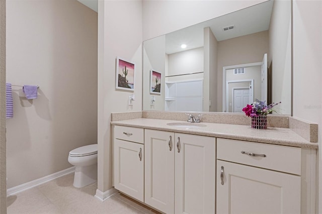 bathroom with vanity, tile patterned floors, and toilet