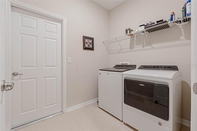 washroom with washing machine and clothes dryer