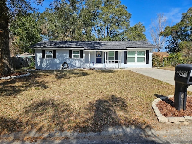 single story home with covered porch and a front lawn