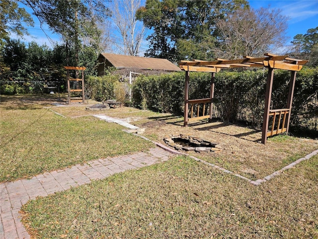 view of yard featuring an outdoor fire pit and a pergola