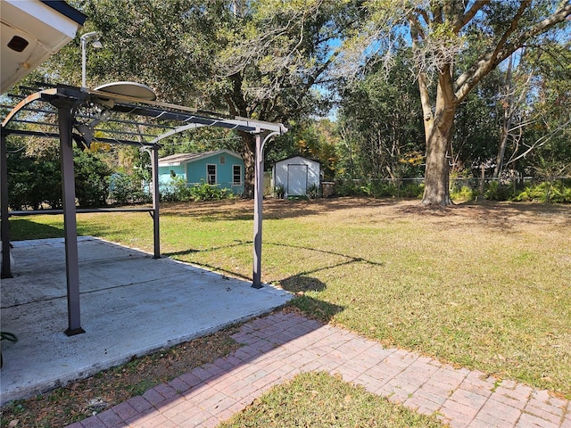 view of yard with a patio area, a shed, and a pergola