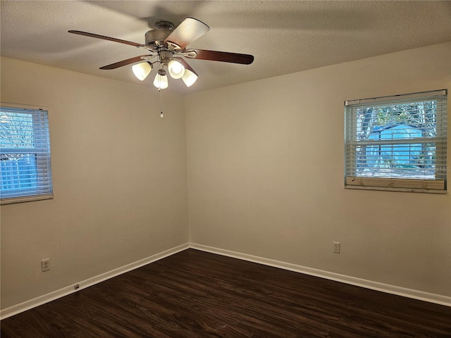 spare room with ceiling fan, dark wood-type flooring, and a textured ceiling