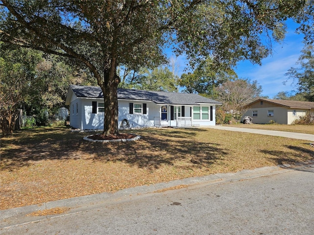 single story home featuring a front yard and covered porch