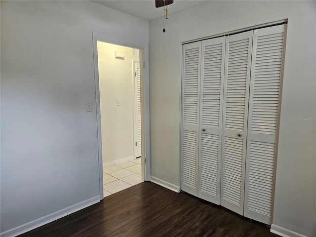 unfurnished bedroom featuring wood-type flooring and a closet