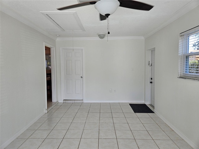 unfurnished room with light tile patterned floors, a textured ceiling, ornamental molding, and ceiling fan