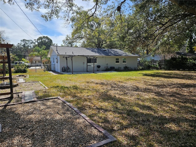 back of property featuring a lawn