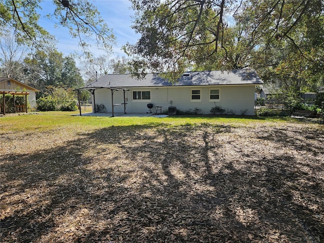 back of property with a patio and a lawn