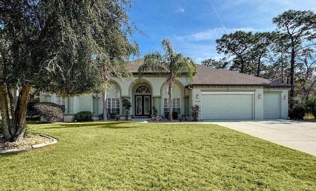 view of front of home with a garage and a front lawn