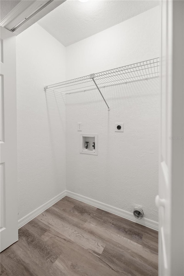 laundry room featuring hardwood / wood-style flooring, hookup for an electric dryer, and hookup for a washing machine