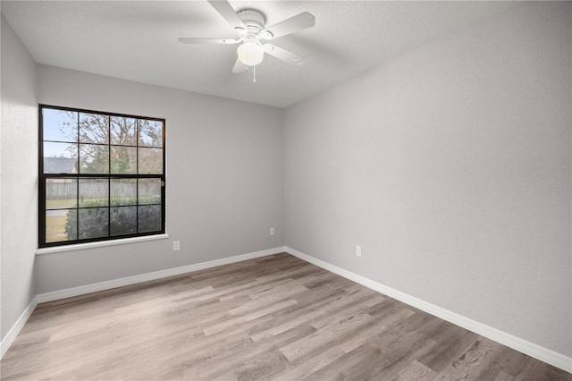 empty room featuring ceiling fan and light wood-type flooring