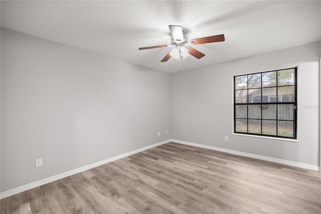 unfurnished room featuring ceiling fan and light wood-type flooring