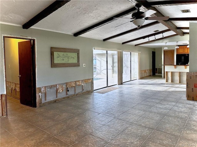 unfurnished living room with lofted ceiling with beams, ceiling fan, visible vents, and a textured ceiling