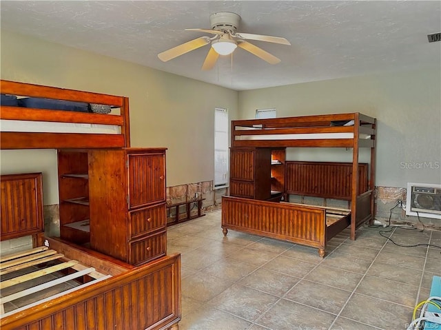 tiled bedroom with an AC wall unit