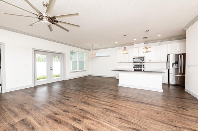 unfurnished living room with baseboards, dark wood-style floors, ornamental molding, french doors, and recessed lighting