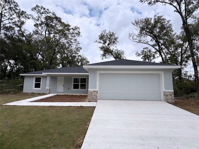 view of front of home with a garage and a front lawn