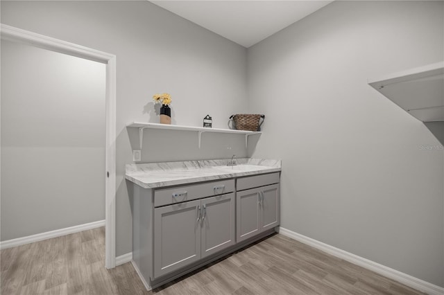 laundry room with sink and light wood-type flooring