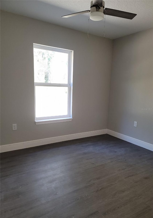 unfurnished room featuring ceiling fan, a textured ceiling, and dark hardwood / wood-style flooring