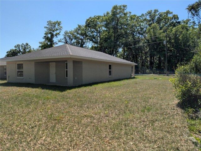 14259 SE 33rd Ter, Summerfield, FL 34491 - view of home's exterior with a lawn and stucco siding
