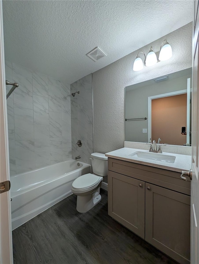 14259 SE 33rd Ter, Summerfield, FL 34491 - bathroom featuring wood finished floors, a textured wall, toilet, visible vents, and a textured ceiling