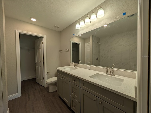 14259 SE 33rd Ter, Summerfield, FL 34491 - full bathroom featuring toilet, wood finished floors, a sink, and tiled shower