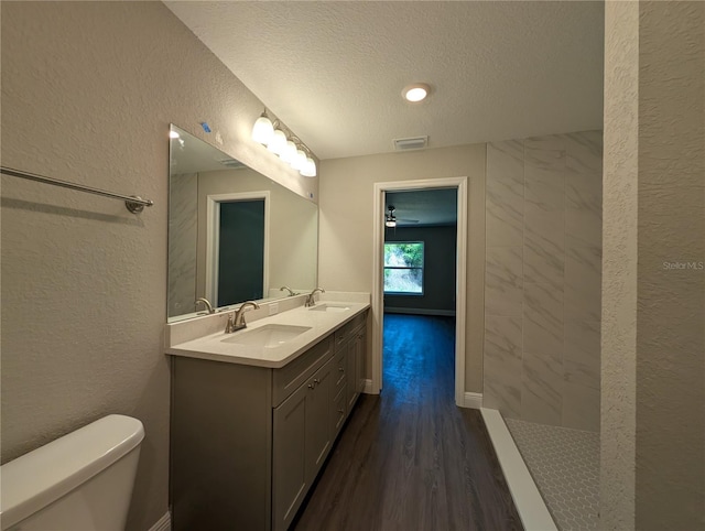 14259 SE 33rd Ter, Summerfield, FL 34491 - bathroom with toilet, a sink, visible vents, and a textured ceiling