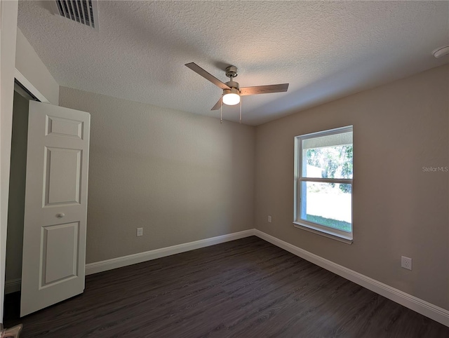 14259 SE 33rd Ter, Summerfield, FL 34491 - unfurnished room with visible vents, dark wood-type flooring, baseboards, a textured ceiling, and ceiling fan