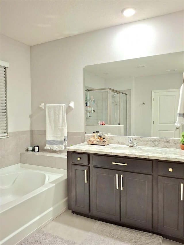 bathroom featuring vanity and separate shower and tub