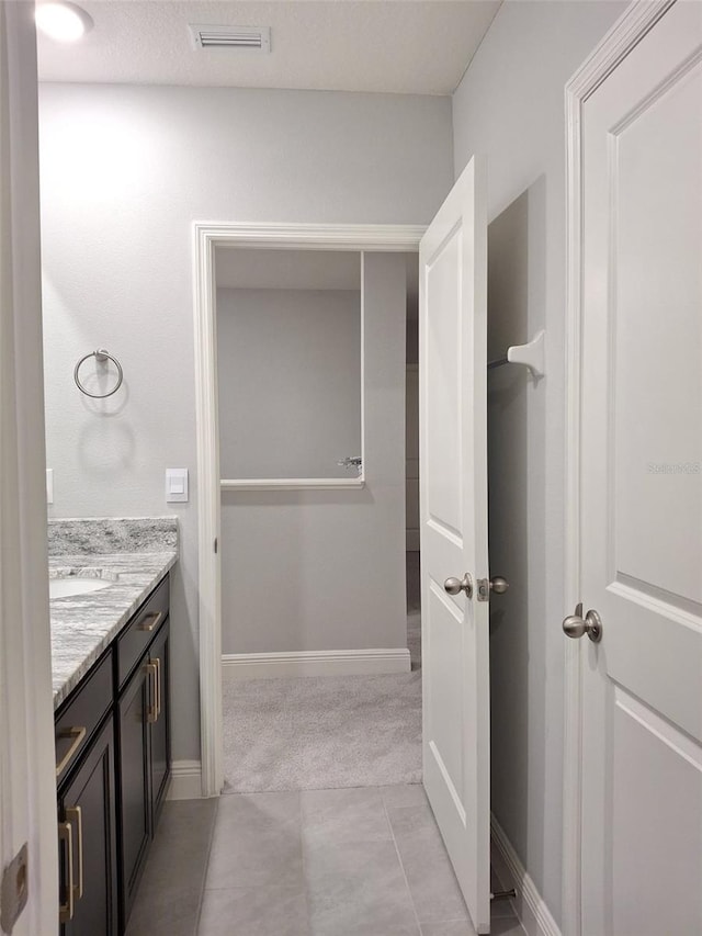 bathroom with vanity and tile patterned flooring