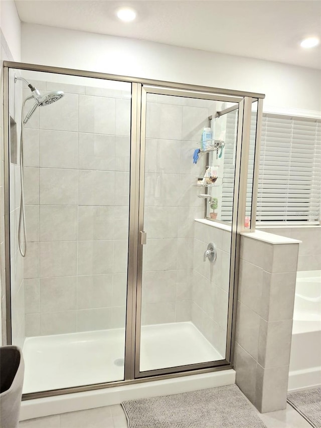 bathroom featuring tile patterned flooring and an enclosed shower