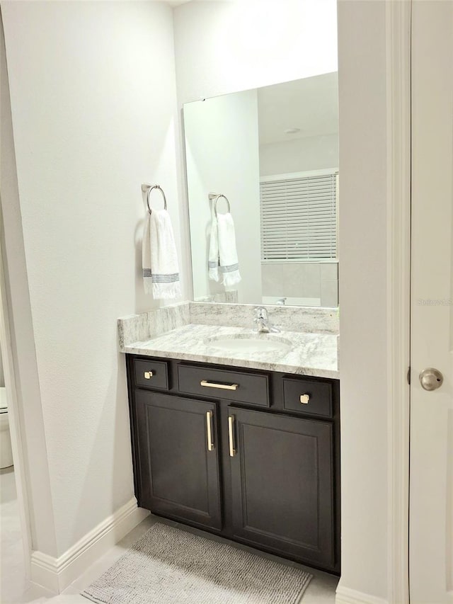 bathroom featuring vanity and toilet