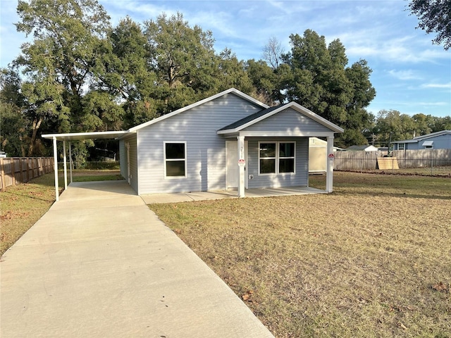 view of front of property with a carport and a front yard