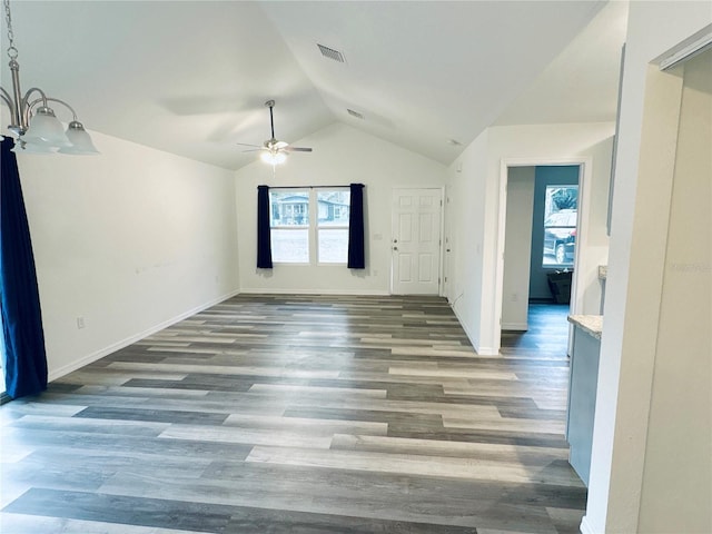 bonus room featuring dark wood-type flooring, vaulted ceiling, and ceiling fan with notable chandelier