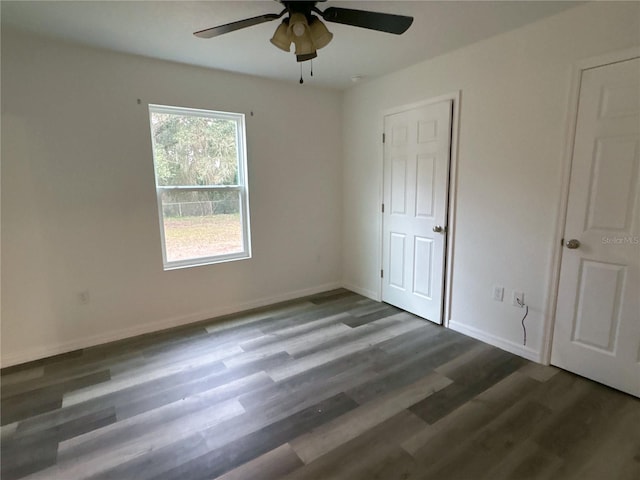 unfurnished bedroom with dark wood-type flooring and ceiling fan