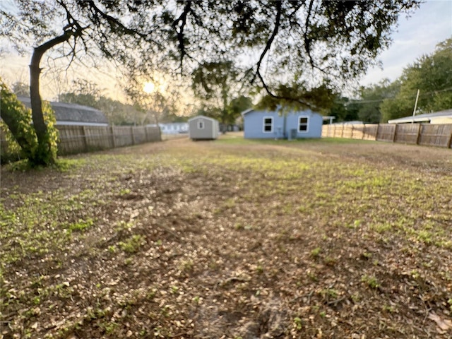 yard at dusk with a storage unit