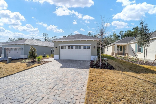 ranch-style home featuring a garage and a front yard