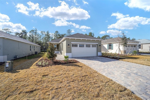 ranch-style house with a garage and a front lawn