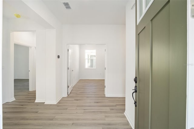 hallway with light hardwood / wood-style flooring