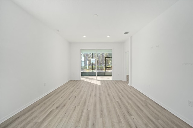 spare room with light wood-type flooring