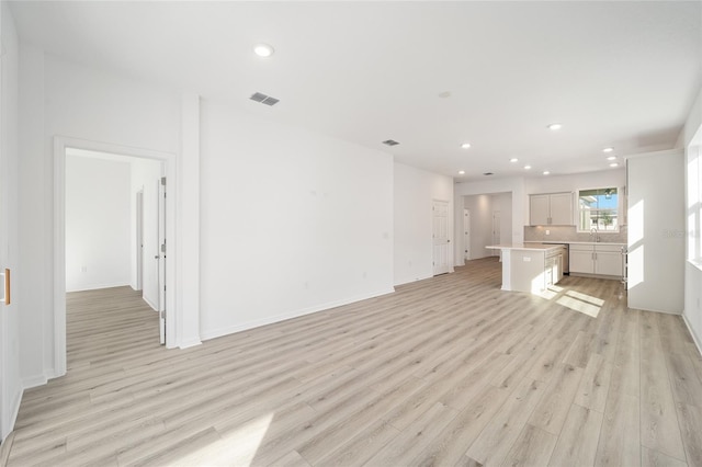 unfurnished living room featuring light wood-type flooring