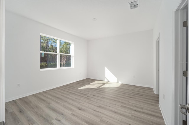 spare room featuring light hardwood / wood-style floors