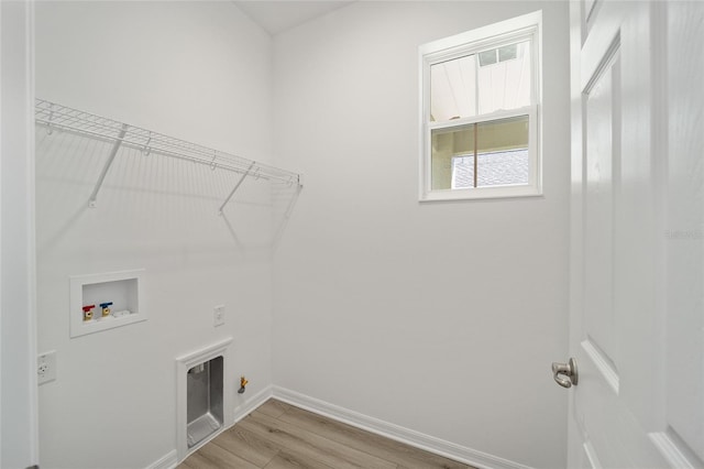 clothes washing area featuring hookup for a washing machine, hookup for an electric dryer, and light wood-type flooring