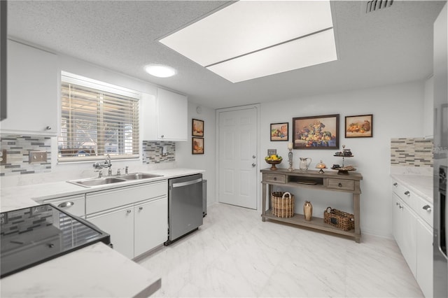 kitchen featuring white cabinetry, sink, stainless steel dishwasher, and backsplash