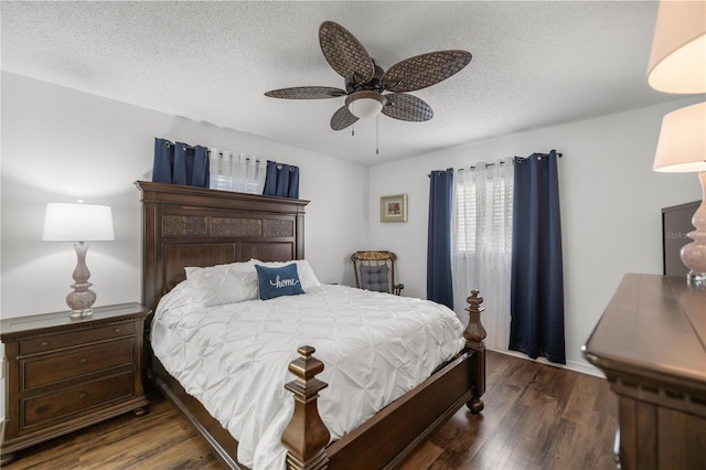 bedroom featuring a textured ceiling, dark wood-type flooring, and ceiling fan