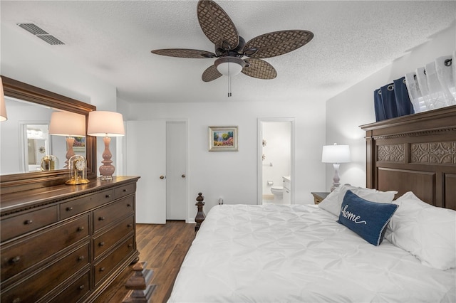 bedroom with a textured ceiling, dark hardwood / wood-style floors, ceiling fan, and ensuite bathroom