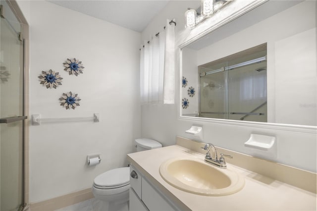 bathroom with vanity, toilet, an enclosed shower, and tile patterned flooring