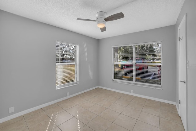 tiled spare room featuring ceiling fan and a textured ceiling