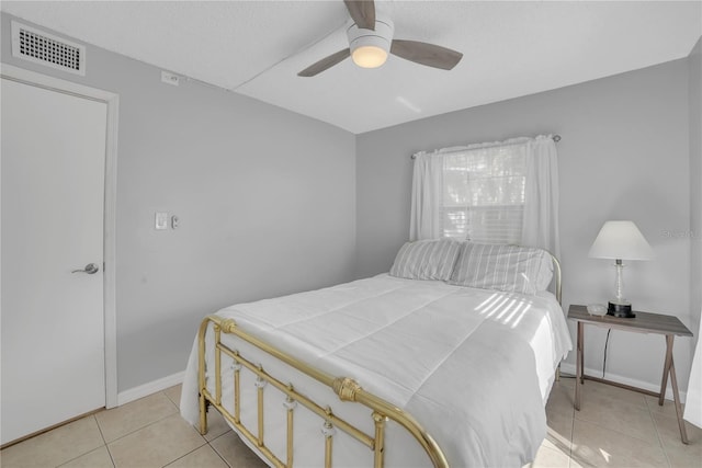 bedroom with ceiling fan and light tile patterned flooring